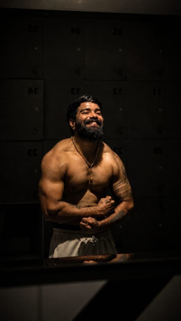 Wildflow Thamizhan founder Manikandan smiling and posing in gym attire